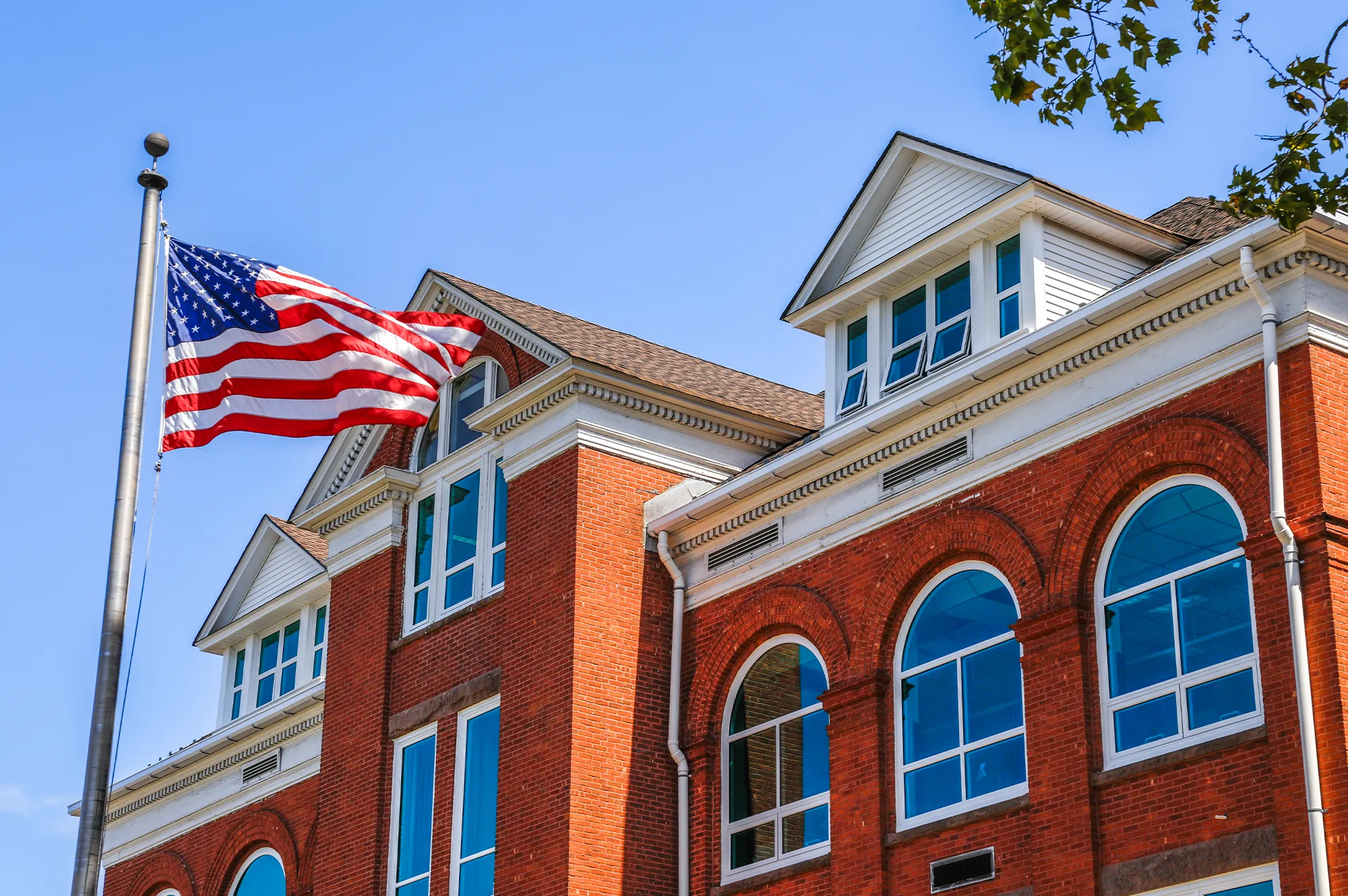 Man Using Measuring Tape in Factory Setting Man Using Measuring Tape in Factory Setting