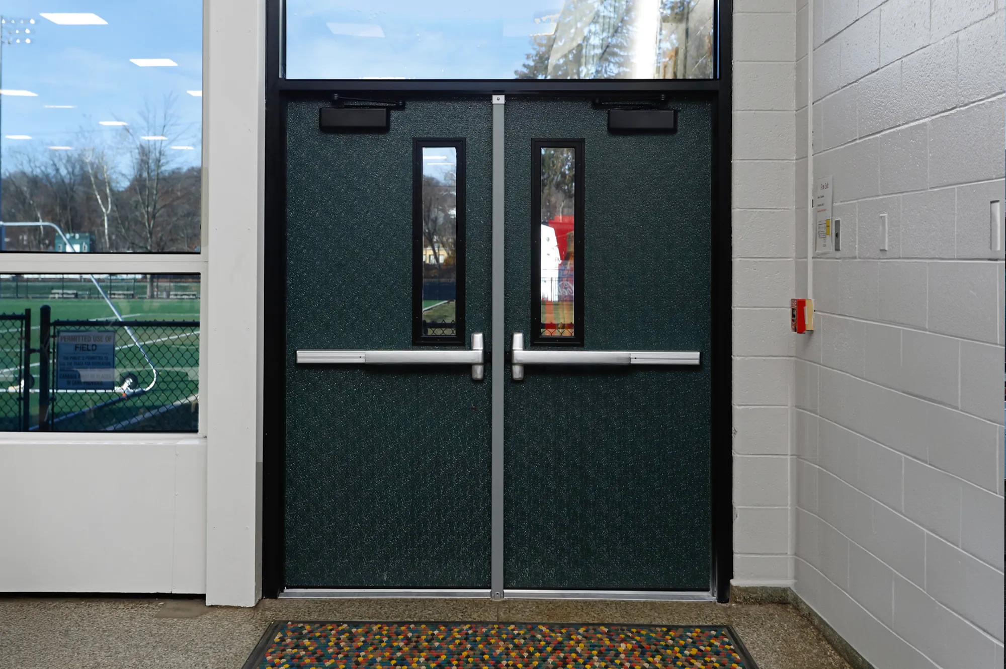 Man Using Measuring Tape in Factory Setting Man Using Measuring Tape in Factory Setting